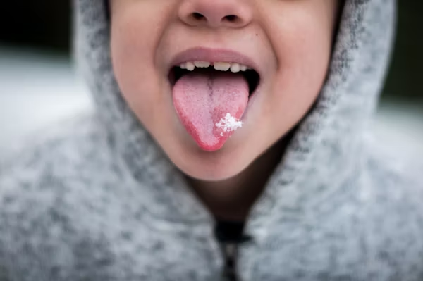 close-up shot of a child's tongue with some snow on it