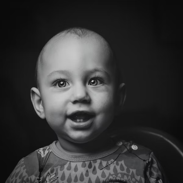 a black and white photo of a baby