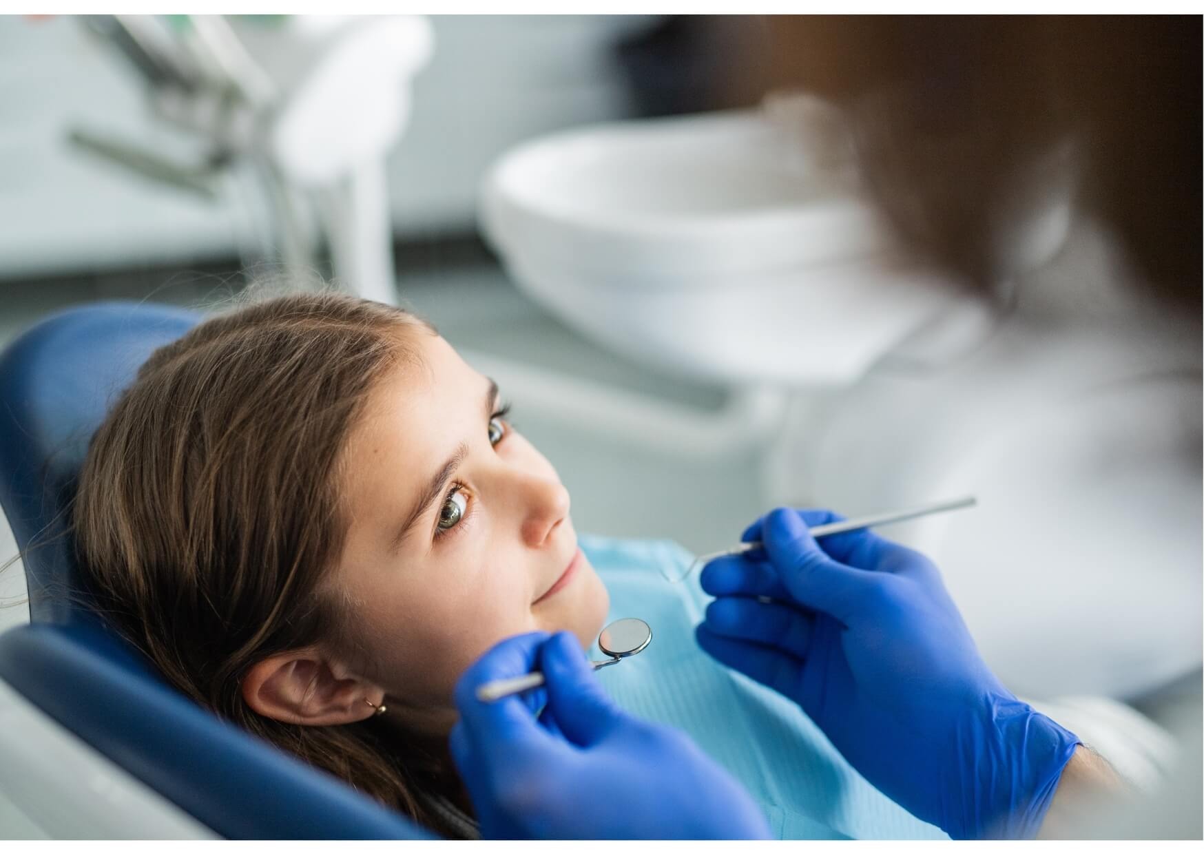 Pediatric dentist examining a child’s teeth during a gentle and friendly dental appointment for kids