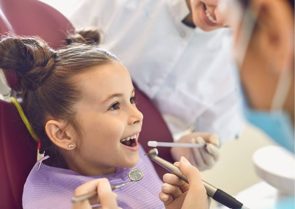 Young child receiving a preventive dental exam, highlighting how dental sealants help protect kids’ teeth from cavities and decay.